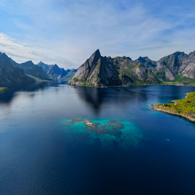 The Reine fjord surrounded by steep mountains and clear water